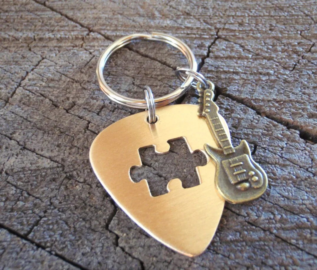 Guitar pick key ring with cutout puzzle piece in bronze and brass guitar charm
